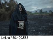 skull being held by male mage black clothes. Стоковое фото, агентство Ingram Publishing / Фотобанк Лори