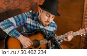 medium shot musician playing guitar 3. Стоковое фото, агентство Ingram Publishing / Фотобанк Лори