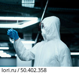 person wearing prevention suit taking samples. Стоковое фото, агентство Ingram Publishing / Фотобанк Лори