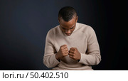 portrait man sitting with clenched fists. Стоковое фото, агентство Ingram Publishing / Фотобанк Лори