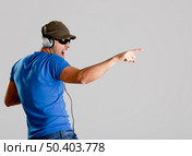 Happy young man with headphones listening music. Стоковое фото, агентство Ingram Publishing / Фотобанк Лори