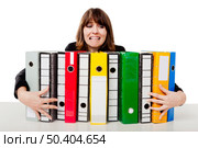 Stressed woman in the office holding  folders. Стоковое фото, агентство Ingram Publishing / Фотобанк Лори