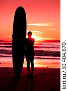 Surfer girl with surfboard at sunset beach. Стоковое фото, агентство Ingram Publishing / Фотобанк Лори