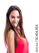 Beautiful young woman making  a grimace with her tongue off, isolated over a white background. Стоковое фото, агентство Ingram Publishing / Фотобанк Лори