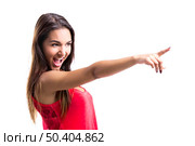 Beautiful young woman pointing to something, isolated over a white background. Стоковое фото, агентство Ingram Publishing / Фотобанк Лори