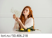 front view beautiful woman posing with spring flowers table. Стоковое фото, агентство Ingram Publishing / Фотобанк Лори