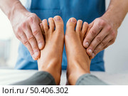 front view male osteopathic therapist checking female patient s toes. Стоковое фото, агентство Ingram Publishing / Фотобанк Лори