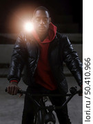 sitting his bicycle night. Стоковое фото, агентство Ingram Publishing / Фотобанк Лори