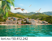 View on Sveti Stefan and its beach in summer full of tourists. Sveti Stefan and its beach. Стоковое фото, агентство Ingram Publishing / Фотобанк Лори