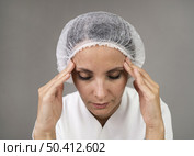 close up doctor experiencing headache. Стоковое фото, агентство Ingram Publishing / Фотобанк Лори