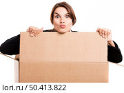 Happy business woman appear inside a big card box, isolated over white background. Стоковое фото, агентство Ingram Publishing / Фотобанк Лори