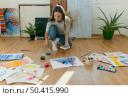 long shot woman painting floor. Стоковое фото, агентство Ingram Publishing / Фотобанк Лори