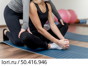 workout with personal trainer lotus position. Стоковое фото, агентство Ingram Publishing / Фотобанк Лори