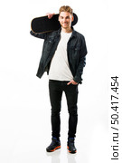 Studio portrait of a young man posing with a skateboard. Стоковое фото, агентство Ingram Publishing / Фотобанк Лори