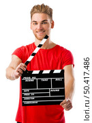 Casual young man holding a clapboard, over a white background. Стоковое фото, агентство Ingram Publishing / Фотобанк Лори