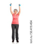  Happy fitness old woman lifting dumbbells and smiling. Стоковое фото, агентство Ingram Publishing / Фотобанк Лори