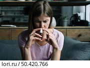 front view sick woman sniffing nasal spray. Стоковое фото, агентство Ingram Publishing / Фотобанк Лори