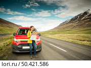 Female tourist in Iceland seeing the map. Стоковое фото, агентство Ingram Publishing / Фотобанк Лори
