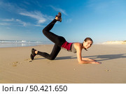 Shoot of a beautiful woman exercising herself in the beach. Стоковое фото, агентство Ingram Publishing / Фотобанк Лори