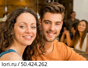 Happy couple at the restaurant talking and smiling. Стоковое фото, агентство Ingram Publishing / Фотобанк Лори