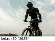 low angle man mountain biking equipment. Стоковое фото, агентство Ingram Publishing / Фотобанк Лори
