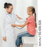medium shot cute girl checking doctor. Стоковое фото, агентство Ingram Publishing / Фотобанк Лори