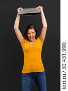 Angry woman trowing her laptop into the floor. Стоковое фото, агентство Ingram Publishing / Фотобанк Лори