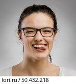 Cute portrait of a woman biting her tongue. Стоковое фото, агентство Ingram Publishing / Фотобанк Лори