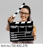 Portrait of beautilful woman holding a clapboard. Стоковое фото, агентство Ingram Publishing / Фотобанк Лори