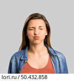 Portrait of a beautiful woman making a pout expression. Стоковое фото, агентство Ingram Publishing / Фотобанк Лори