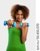 Beautiful African American woman lifting weights . Стоковое фото, агентство Ingram Publishing / Фотобанк Лори