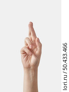 Inner palm side female hand in sign language alphabet gesture letter R. Finger spelling in american alphabet spelling isolated on white background.. Female hand alphabet finger spelling R letter on white. Стоковое фото, агентство Ingram Publishing / Фотобанк Лори