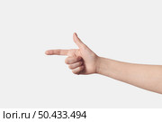 Woman hand pointing right with thumb up, sign language L letter in finger alphabet, got ya gesturing isolated on white background.. Pointing with one finger woman right hand on white. Стоковое фото, агентство Ingram Publishing / Фотобанк Лори