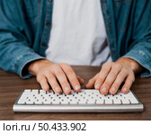 close up person using wireless mac keyboard. Редакционное фото, агентство Ingram Publishing / Фотобанк Лори