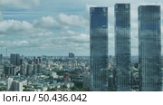 Three skyscrapers towering over Moscow cityscape under cloudy sky. Стоковое видео, видеограф Mikhail Davidovich / Фотобанк Лори