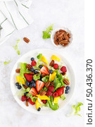 Fruit and berry salad with strawberry, blueberry, raspberry, mango and pecan nuts. Healthy food, diet. Top view. Стоковое фото, агентство Ingram Publishing / Фотобанк Лори