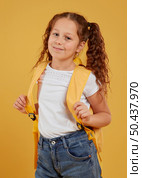 cute girl carrying yellow backpack. Стоковое фото, агентство Ingram Publishing / Фотобанк Лори