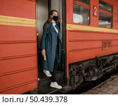 side view woman descends stairs from train. Стоковое фото, агентство Ingram Publishing / Фотобанк Лори
