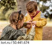 medium shot girl helping brother. Стоковое фото, агентство Ingram Publishing / Фотобанк Лори