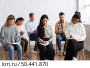 people taking notes group therapy session. Стоковое фото, агентство Ingram Publishing / Фотобанк Лори