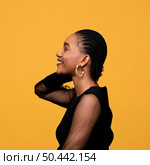 sideways african woman with golden earrings. Стоковое фото, агентство Ingram Publishing / Фотобанк Лори
