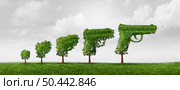 Growing gun use and growth of firearms ownership concept or evolving  laws as a tree shaped as a gun representing public safety and security issues with 3D illustration elements. Стоковое фото, агентство Ingram Publishing / Фотобанк Лори