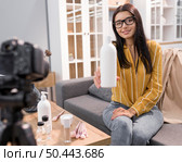 female vlogger home with bottle camera. Стоковое фото, агентство Ingram Publishing / Фотобанк Лори