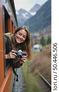 Beautiful happy young woman hangs out of train open window and make photo on vintage analog camera. Travel and explore more wanderlust concept. Female touristin. Стоковое AI-видео, аниматор Sergey Grishin / Фотобанк Лори
