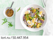 Herring and boiled potato salad with egg, capers and red onion. Top view. Стоковое фото, агентство Ingram Publishing / Фотобанк Лори