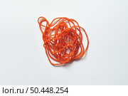 Red tangled thread on white background. Anxiety and mental health awareness.. Red tangled thread on white. Стоковое фото, агентство Ingram Publishing / Фотобанк Лори