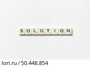 Solution word formed of scrabble elements on white background. Creative template with copy space.. Solution formed of scrabble elements on white background. Стоковое фото, агентство Ingram Publishing / Фотобанк Лори
