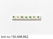 Finance word formed of scrabble blocks on white background. Simple creative backdrop for business presentation.. Finance formed of scrabble blocks on white background. Стоковое фото, агентство Ingram Publishing / Фотобанк Лори