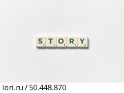 Story word formed of scrabble tiles on white background. Creative simple presentation template idea.. Story formed of scrabble tiles on white background. Стоковое фото, агентство Ingram Publishing / Фотобанк Лори