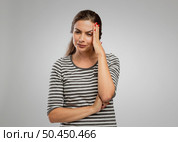 Beautiful woman with hands on head felling a headache. Стоковое фото, агентство Ingram Publishing / Фотобанк Лори